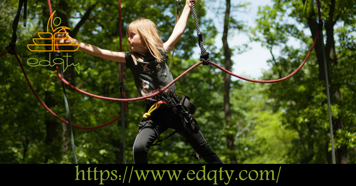 A young girl navigating a ropes course symbolizing the challenges and resilience-building opportunities offered by school camp